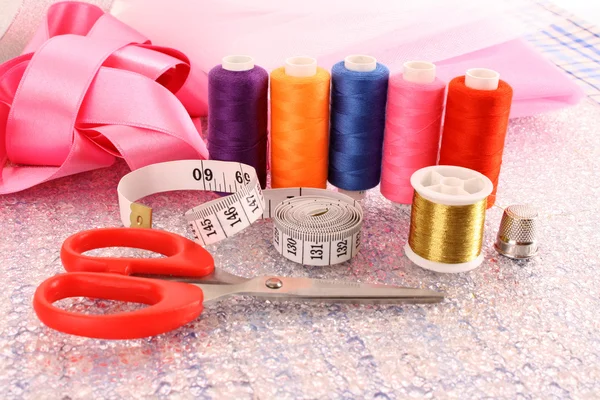 Needle, threads, scissors, ribbons and measuring tape — Stock Photo, Image