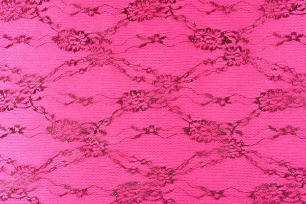 Black lace with pattern on pink background — Stock Photo, Image