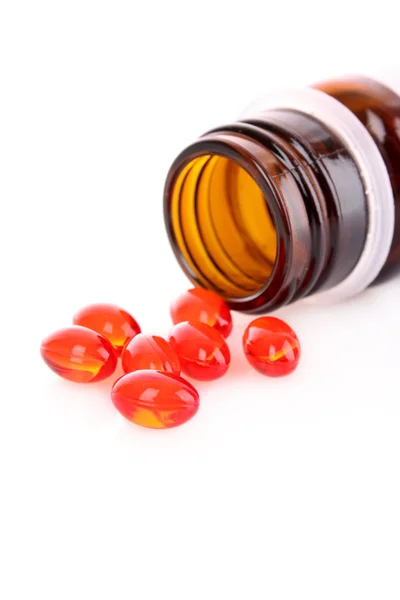 Capsule roșii de vitamine pe fundal alb — Fotografie, imagine de stoc