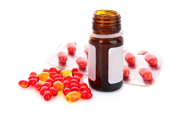Red capsules of vitamins on a white background — Stock Photo, Image