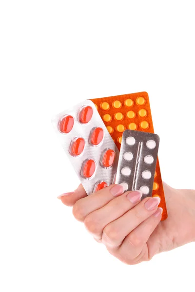 Rode capsules van vitaminen in de hand op een witte achtergrond — Stockfoto