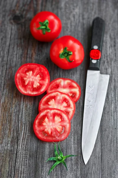 stock image Sliced tomatoes on wooden table