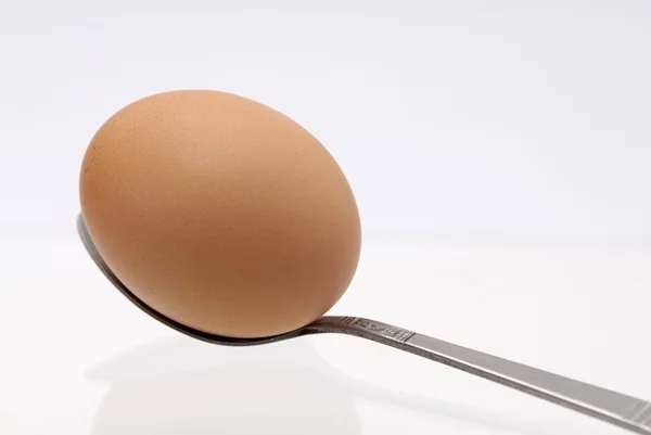Isolated, one boiled egg on a teaspoon. — Stock Photo, Image