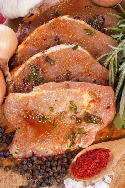 stock image Pork tenderloin marinated with spices on a wooden board