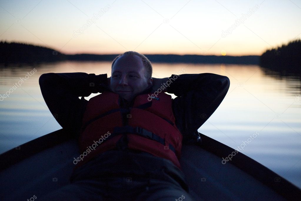 Beautiful life! Young man relaxing on the boat